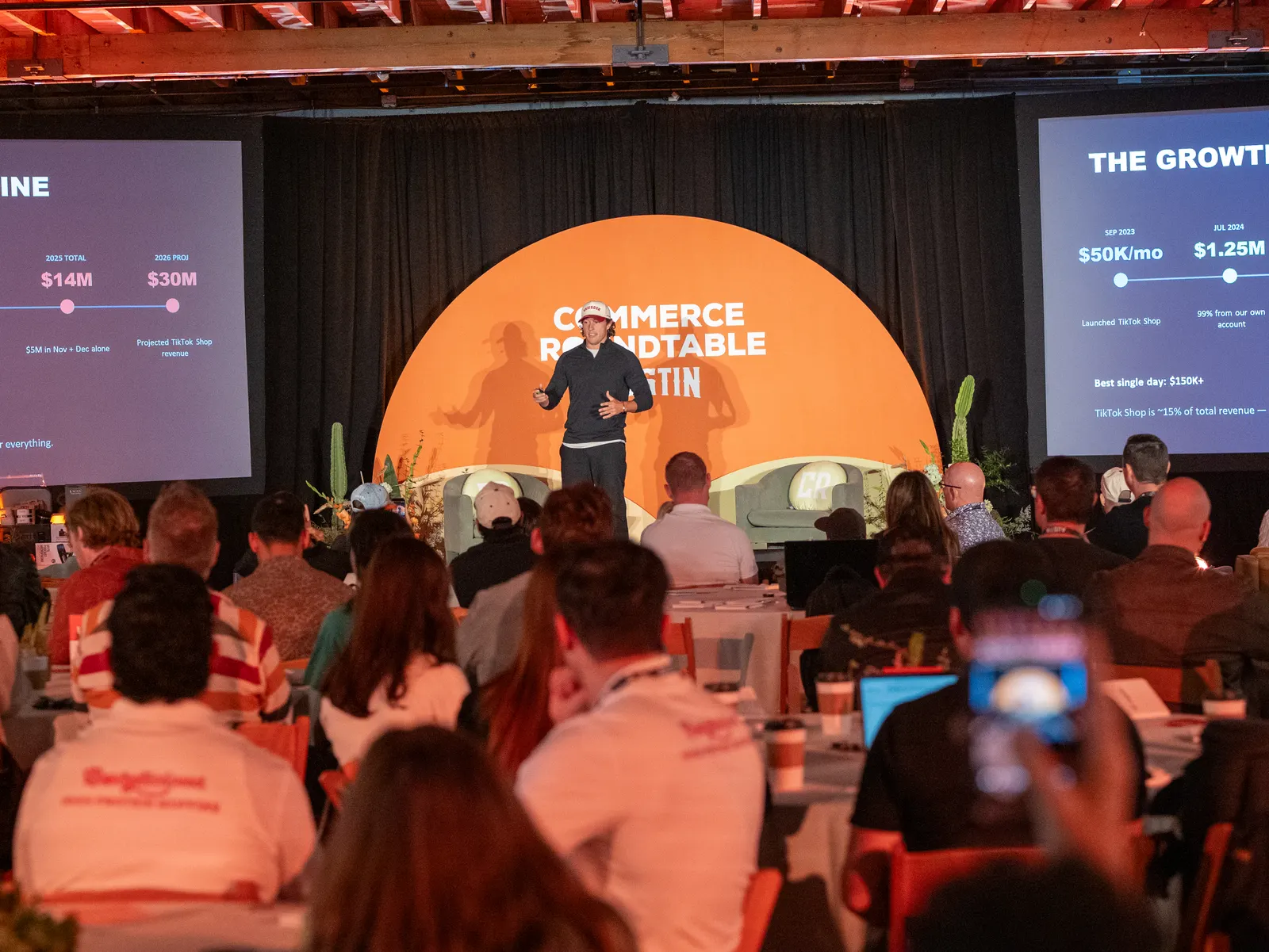 A packed room with phones up during a talk