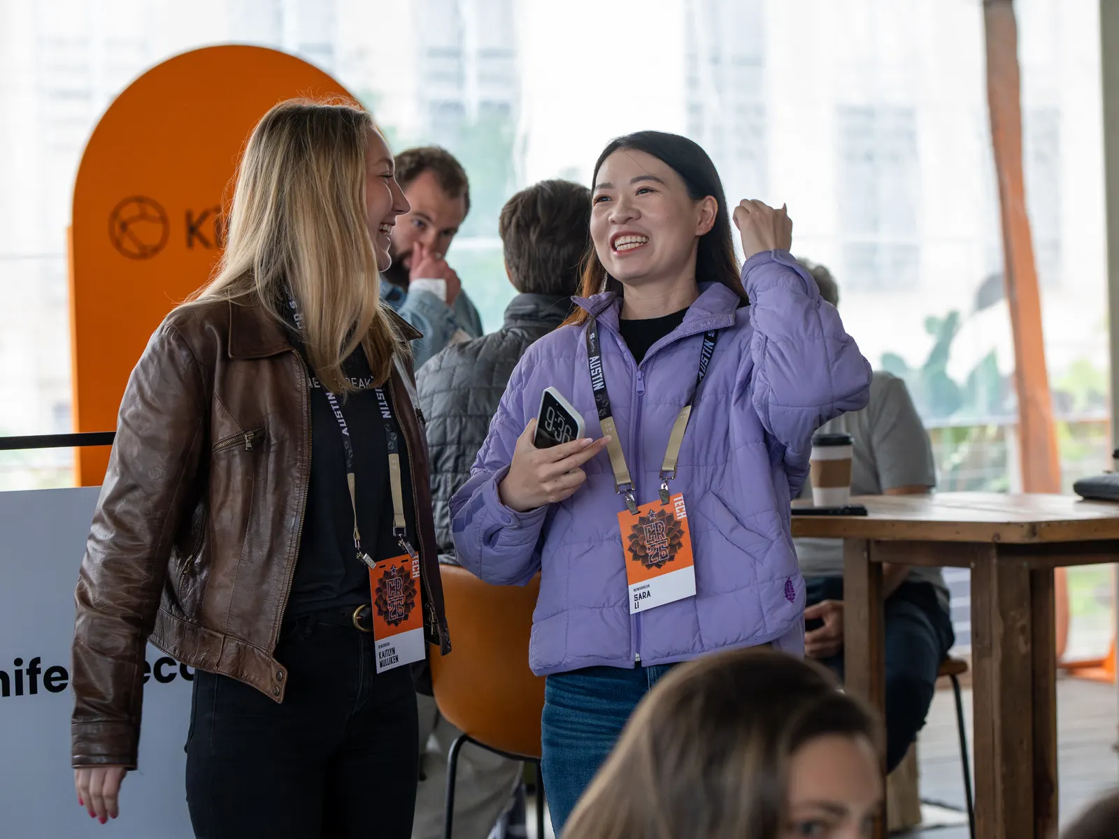 Two attendees laughing together
