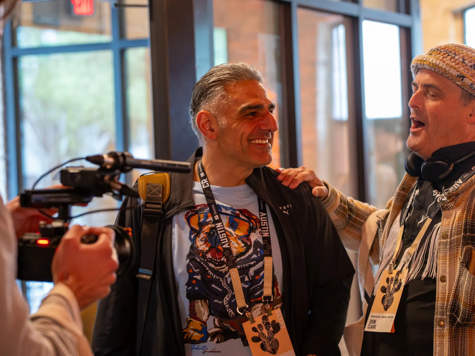 Attendees laughing with the camera crew nearby