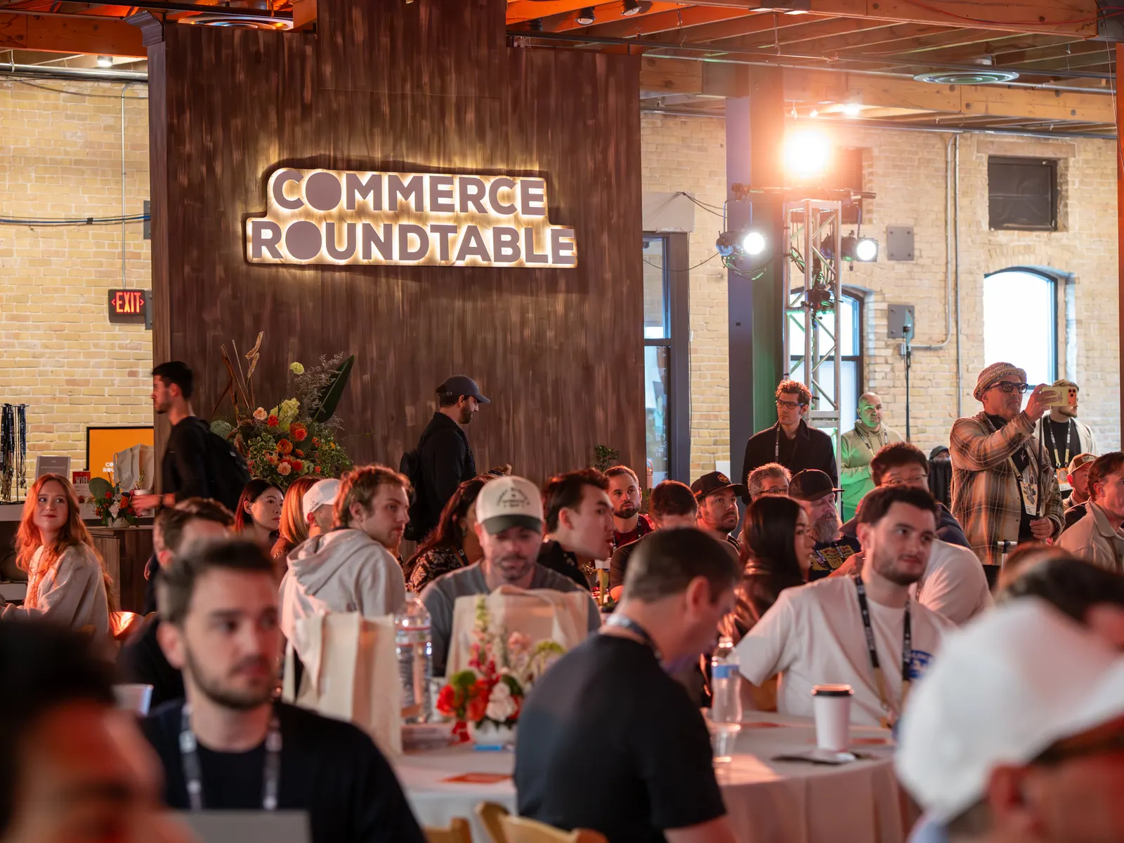 Packed tables under the glowing Commerce Roundtable sign