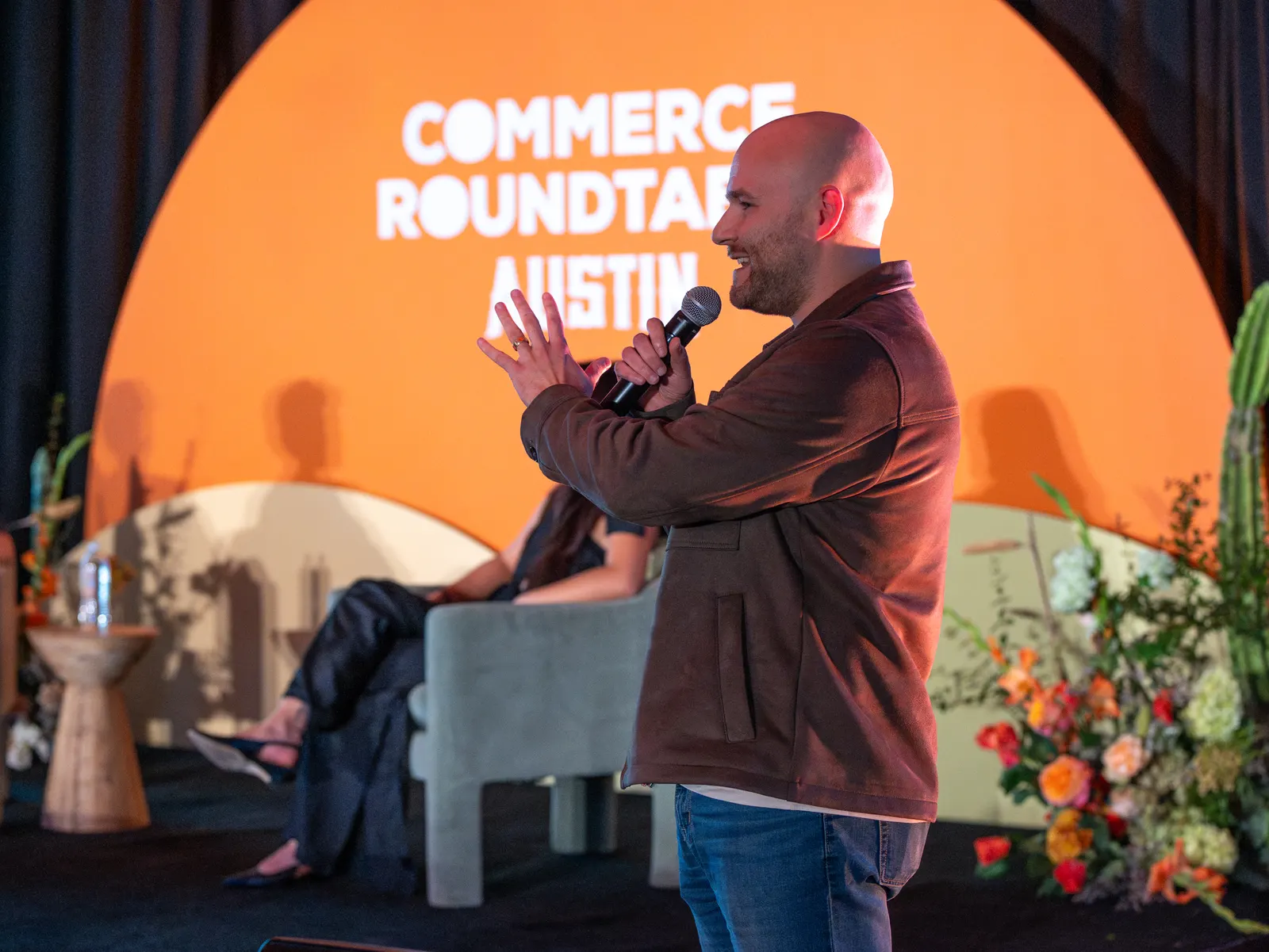 An animated speaker under the orange arch