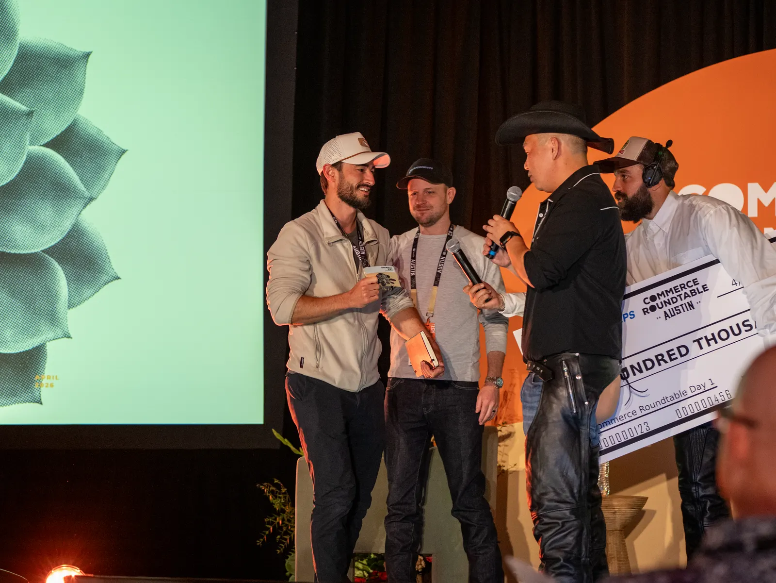 Winners celebrating with a big check