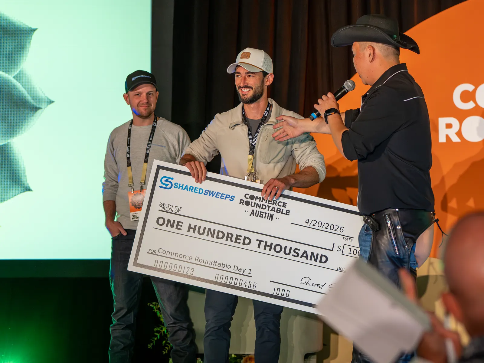 The $100K check handed over by the cowboy hosts