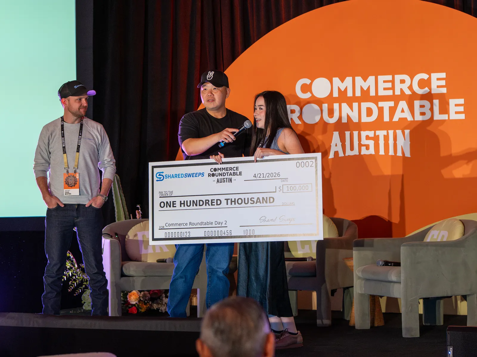 A winner holding the $100K check