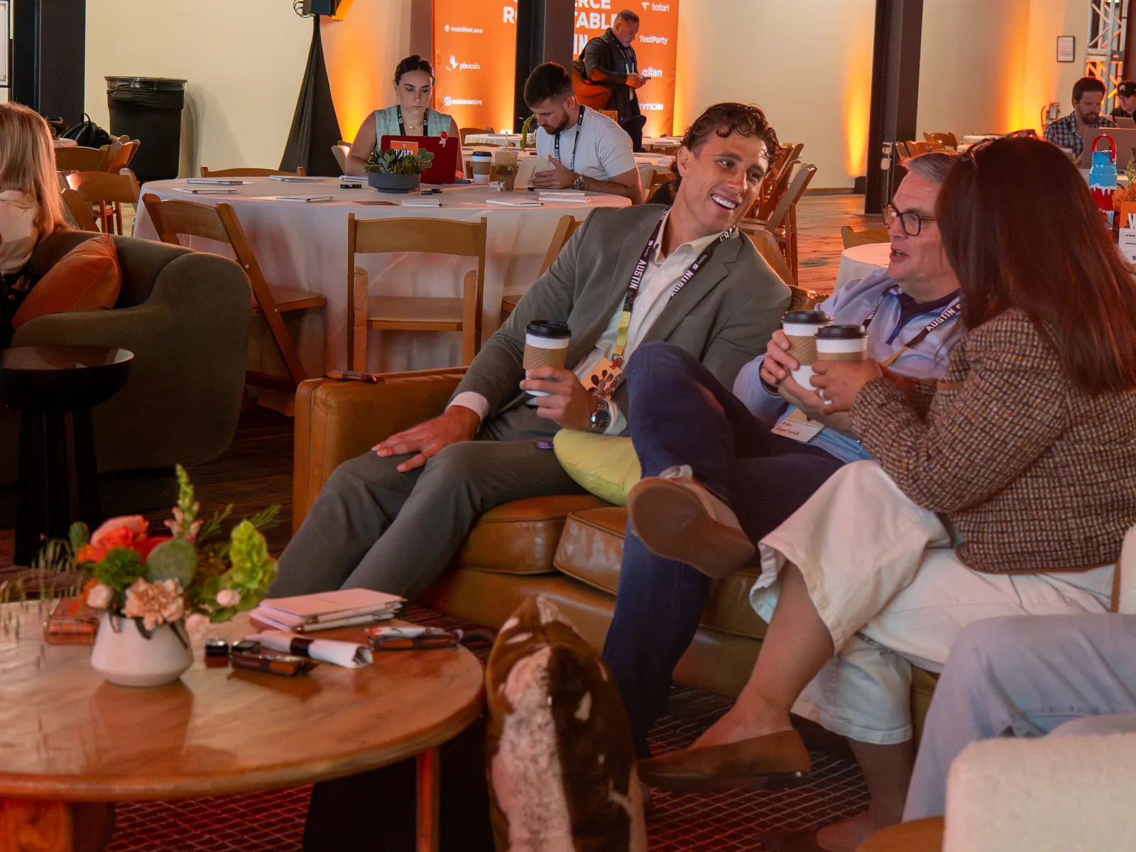 Attendees laughing together in a lounge