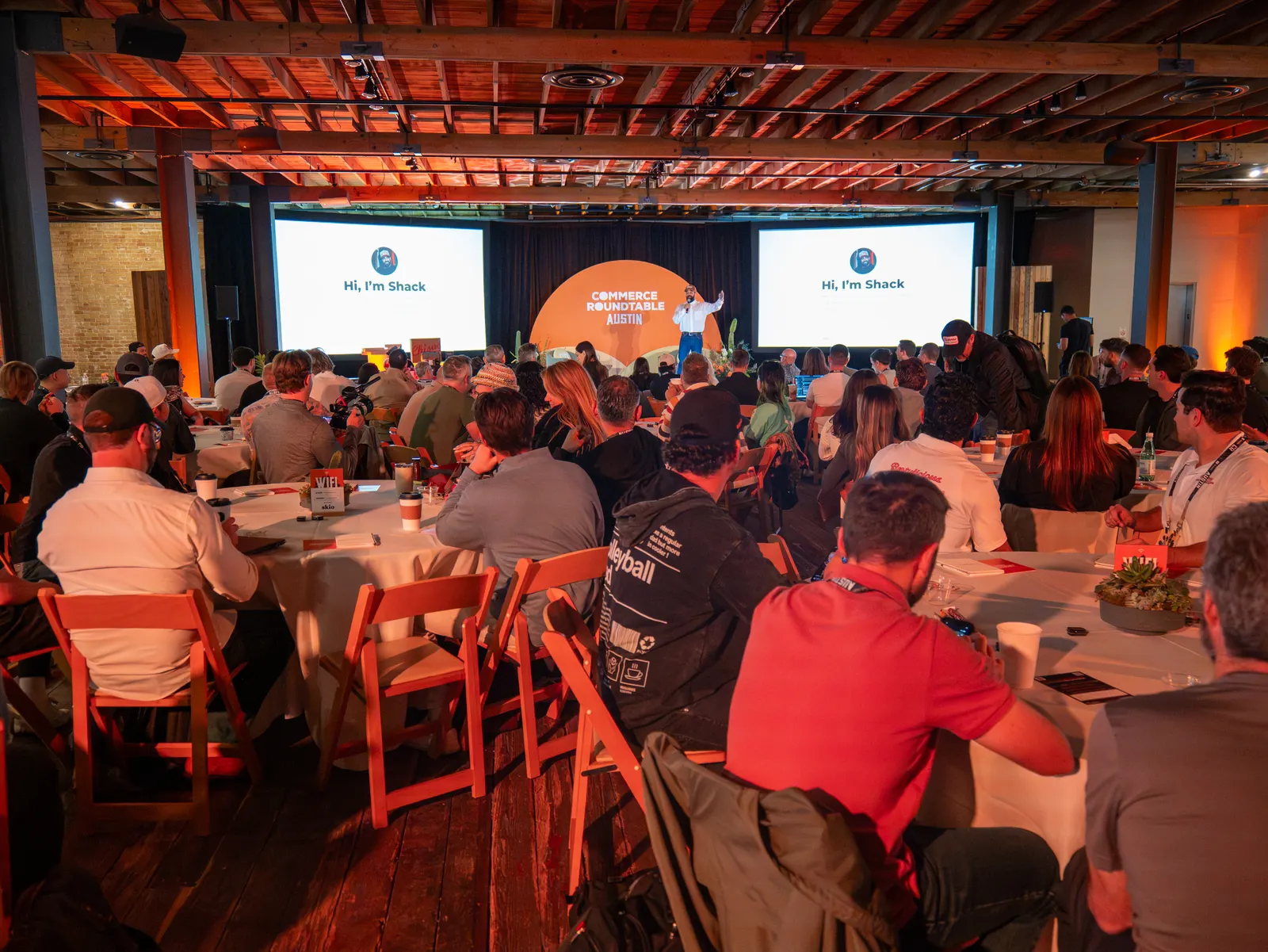 A full room facing the stage and screens