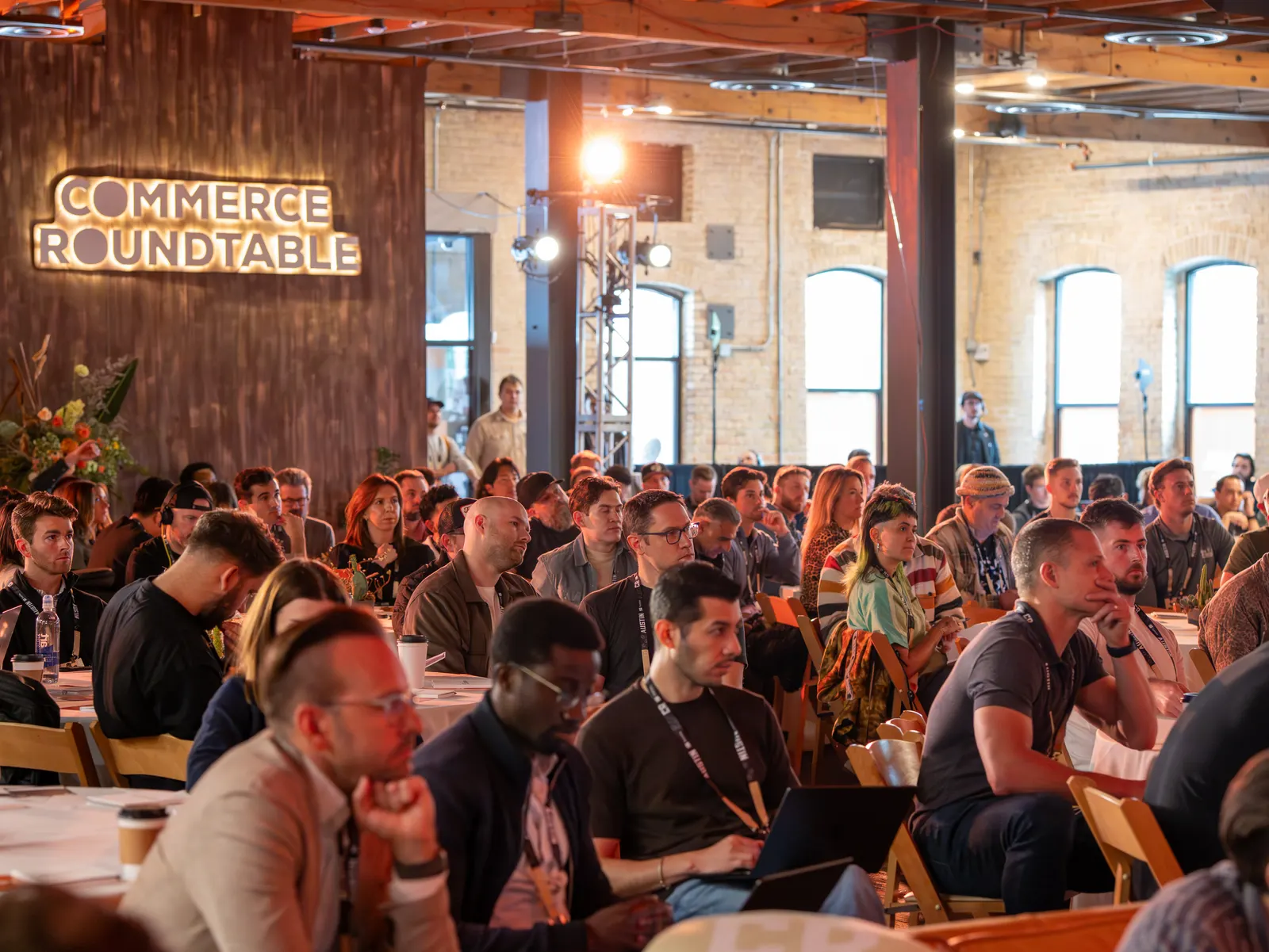 A packed ballroom of engaged attendees