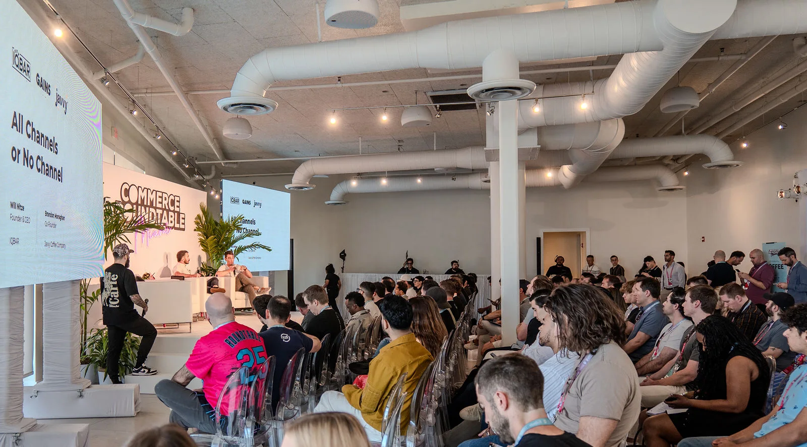 Attendees filling the Miami room for a panel conversation